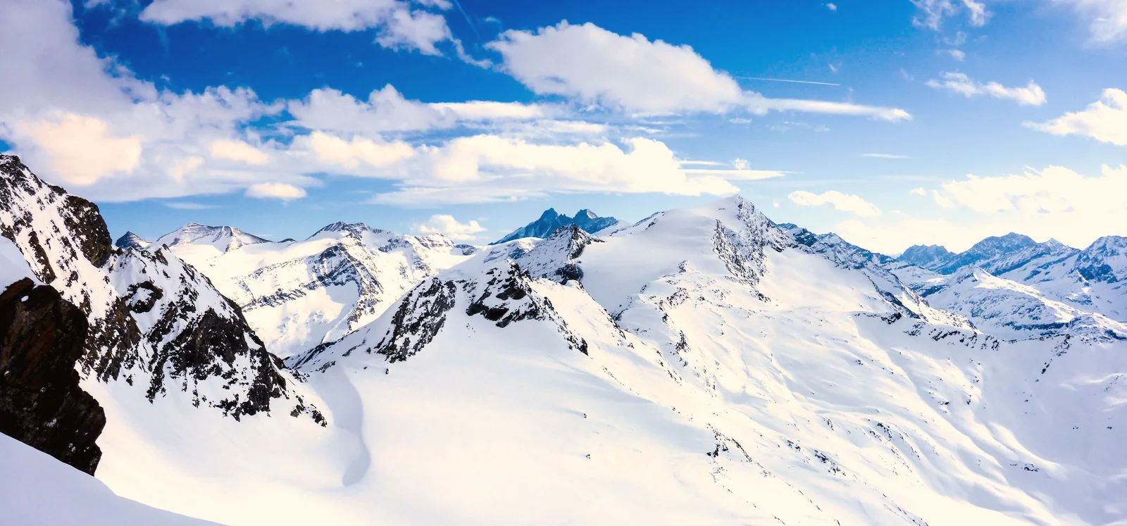 Sunlit snow-covered Alpine peaks